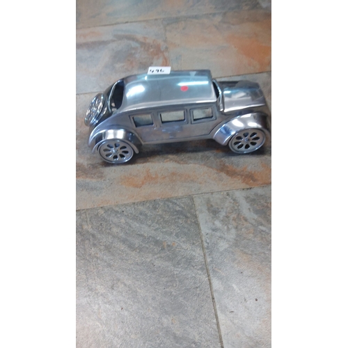 496 - Vintage-style metal model car with sleek, reflective finish and detailed windows and wheels.