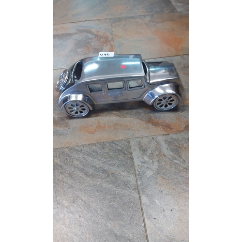 496 - Vintage-style metal model car with sleek, reflective finish and detailed windows and wheels.