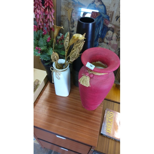 56 - Includes a red ceramic vase with a straw tassel, a white ceramic vase with golden decorative element... 