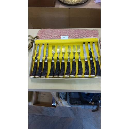 60 - Set of 12 cutlery pieces with antler handles, including 6 knives and 6 forks, in original case.