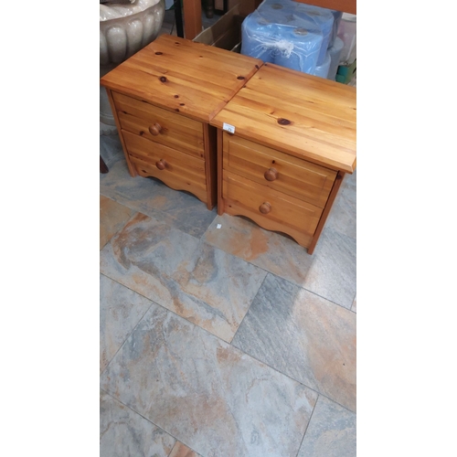 71 - Pair of pine bedside cabinets, each featuring two drawers with rounded wooden knobs and a scalloped ... 