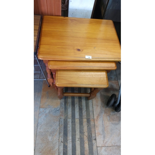 76 - Set of three nesting tables in pinewood, showcasing a natural finish with turned legs.