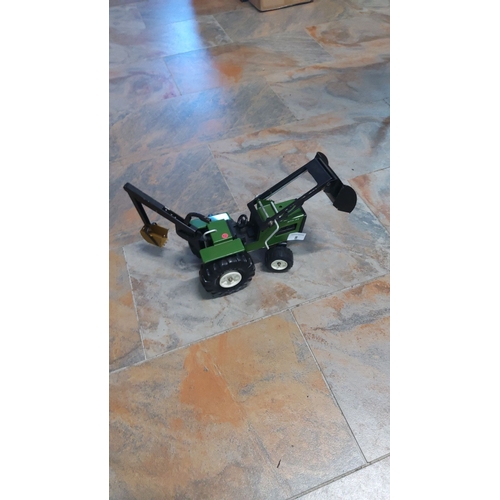 8 - Green toy tractor with front loader and rear excavator attachment. Sturdy metal construction with re... 