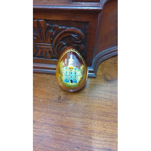 103 - Hand-painted wooden egg with intricate architectural scene, featuring a central domed building.