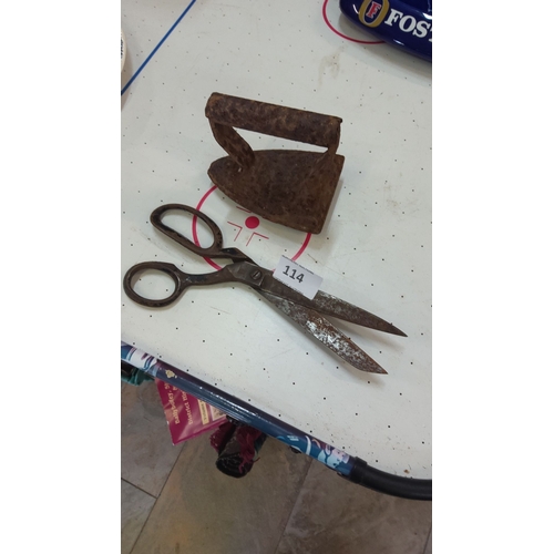114 - Antique iron and vintage scissors from the early 20th century. The iron displays a patina and the sc... 