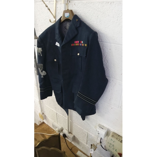 361 - Dark blue Royal Air Force uniform jacket with ribbon bar and insignia, featuring rank stripes on sle... 