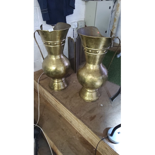 362 - Pair of brass ewers with a hammered finish and elegant handles. Approximately 30 inches tall.