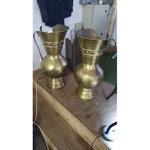 362 - Pair of brass ewers with a hammered finish and elegant handles. Approximately 30 inches tall.