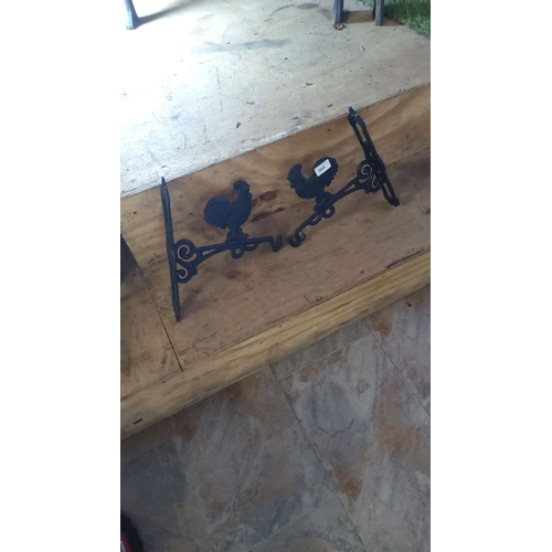 364 - Pair of cast iron rooster hanging basket  brackets with intricate scrollwork. Approximately 9 inches... 