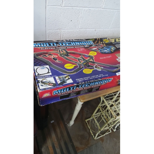376 - Complete boxed slot car track set with loop, elevator, and electronic features. Track size: 285 x 15... 