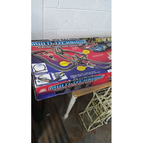376 - Complete boxed slot car track set with loop, elevator, and electronic features. Track size: 285 x 15... 