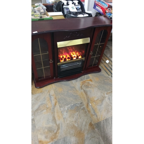 381 - Electric fireplace with mahogany finish and glass-paneled cabinets. Approximately 100 cm high, 130 c... 