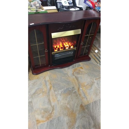 381 - Electric fireplace with mahogany finish and glass-paneled cabinets. Approximately 100 cm high, 130 c... 