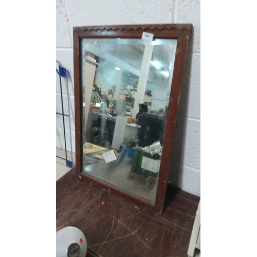 383 - Wooden framed mirror with scalloped top edge design. Approximately 30 x 20 inches.