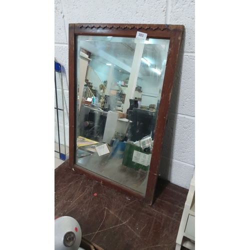 383 - Wooden framed mirror with scalloped top edge design. Approximately 30 x 20 inches.