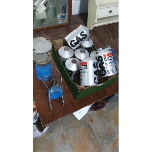 384 - Boxed set of nine Flexolite butane gas canisters with accompanying camping stove.