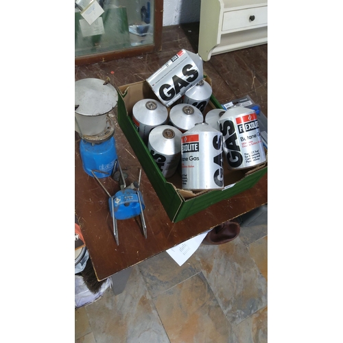 384 - Boxed set of nine Flexolite butane gas canisters with accompanying camping stove.