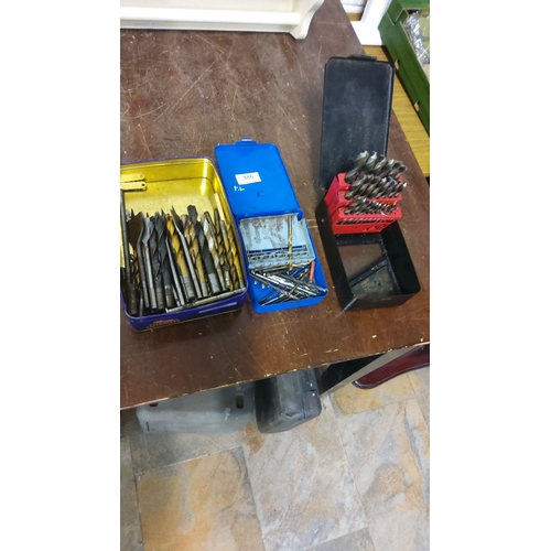 386 - Assorted drill bit sets in metal cases, featuring various sizes and types.