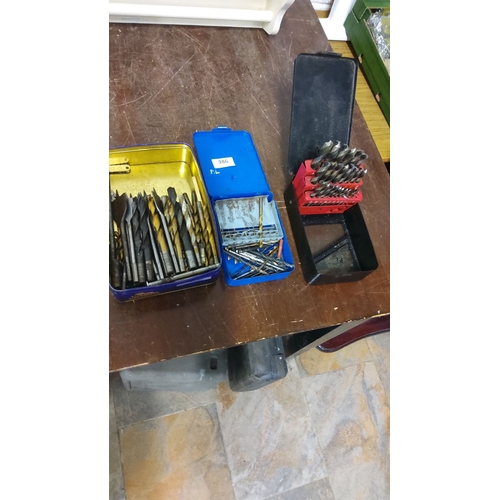 386 - Assorted drill bit sets in metal cases, featuring various sizes and types.