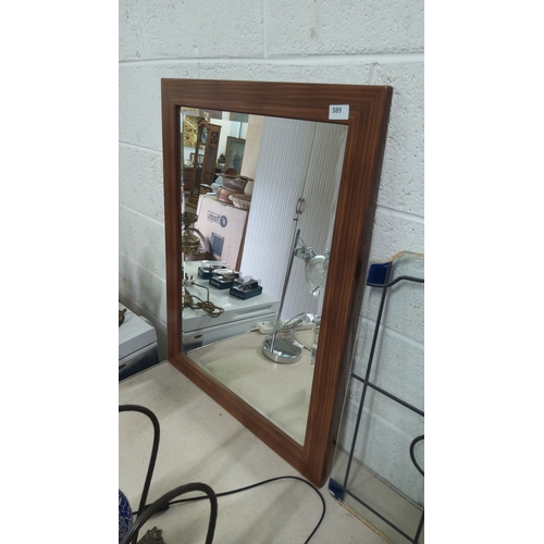 389 - Rectangular wall mirror with wooden frame. Approximately 80 cm x 60 cm.