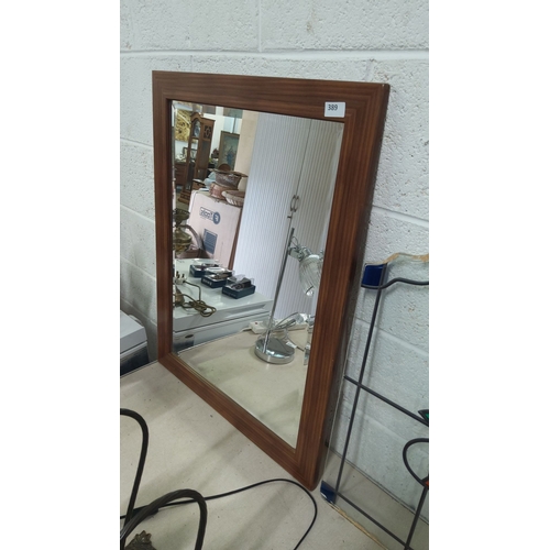 389 - Rectangular wall mirror with wooden frame. Approximately 80 cm x 60 cm.
