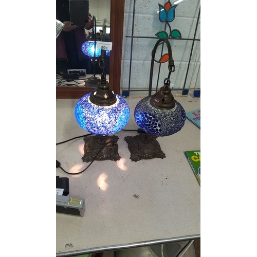 391 - Pair of mosaic glass table lamps with bronze-tone bases and vibrant blue stained glass shades. Appro... 