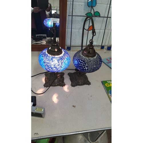 391 - Pair of mosaic glass table lamps with bronze-tone bases and vibrant blue stained glass shades. Appro... 