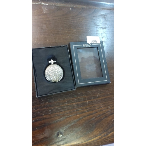396 - Heritage Collection Quebec pocket watch features Roman numerals and a detailed case with a mechanica... 