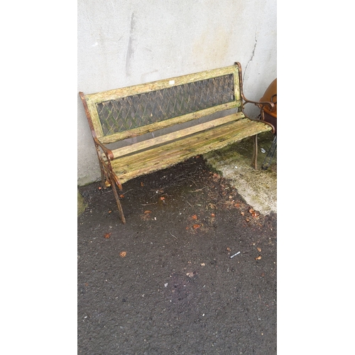 398 - Outdoor wooden and cast iron sides garden bench and a trellis backrest. Approximately 150cm wide, 50... 