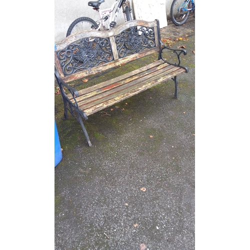 405 - Outdoor bench with ornate cast iron sides featuring floral design backrest. Approximately 120cm long... 