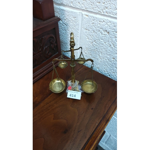 414 - Brass mini balance scales with chain-linked pans, approximately 30 cm tall.