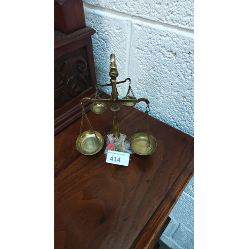 414 - Brass mini balance scales with chain-linked pans, approximately 30 cm tall.