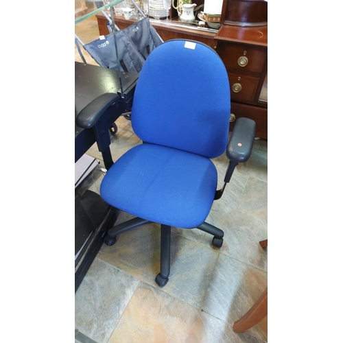 418 - Blue office chair with cushioned seat and back, adjustable armrests, and swivel base. Approximately ... 