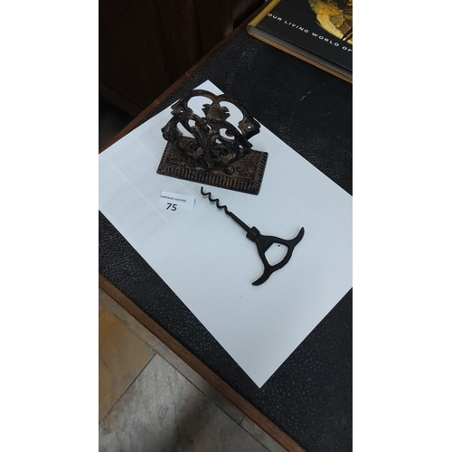 75 - Antique cast iron letter holder featuring ornate scrollwork, paired with a vintage corkscrew.