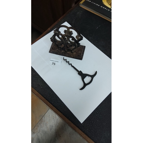 75 - Antique cast iron letter holder featuring ornate scrollwork, paired with a vintage corkscrew.