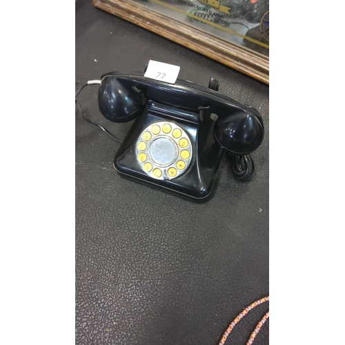 77 - Vintage black button telephone, from the mid-20th century.