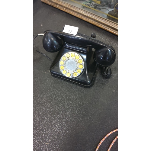 77 - Vintage black button telephone, from the mid-20th century.