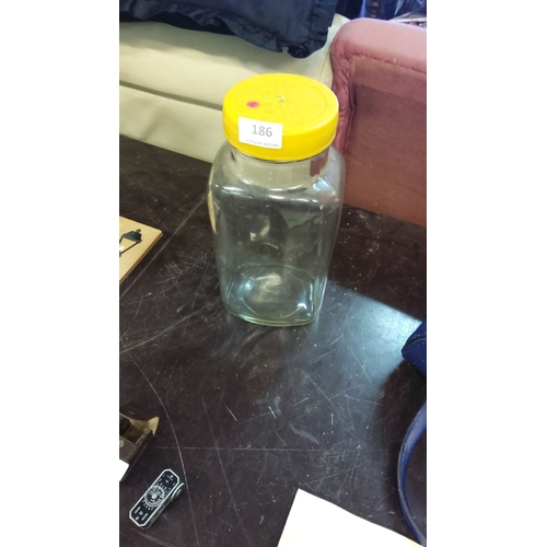 186 - Pascal Murray clear glass sweetie jar with a yellow lid.