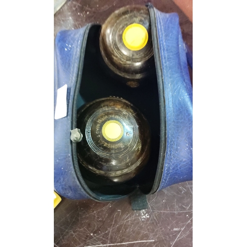 187 - Set of lawn bowls with a blue carrying case, engraved with 