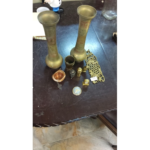 191 - Mixed decorative brass and metalware collection, featuring two ornate vases, intricate trivet, vario... 