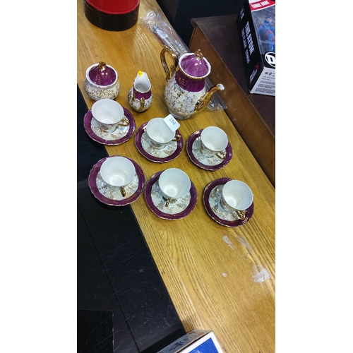 194 - China Coffee set, porcelain with gold accents, floral motif. Includes coffee pot, sugar bowl, creame... 