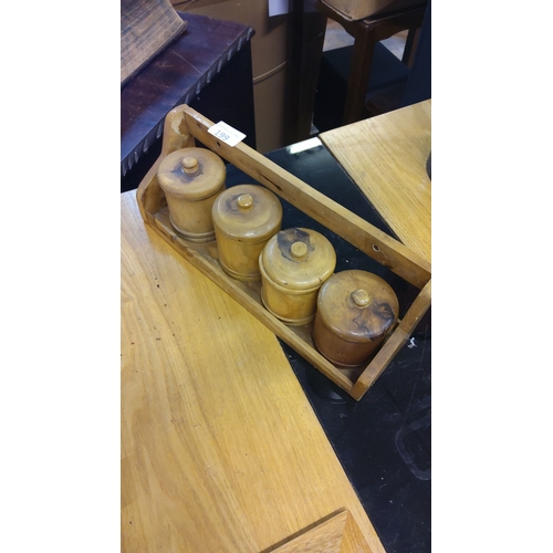 199 - Wooden spice rack with four cylindrical containers, vintage style, made from light wood, and featuri... 