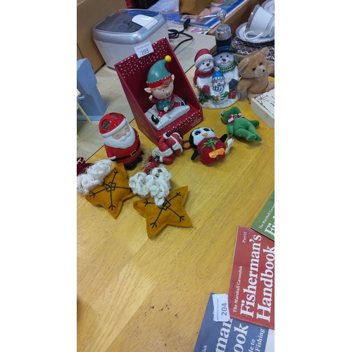 203 - Mixed lot of Christmas ornaments, including various Santa figurines, snowmen, an elf stocking holder... 