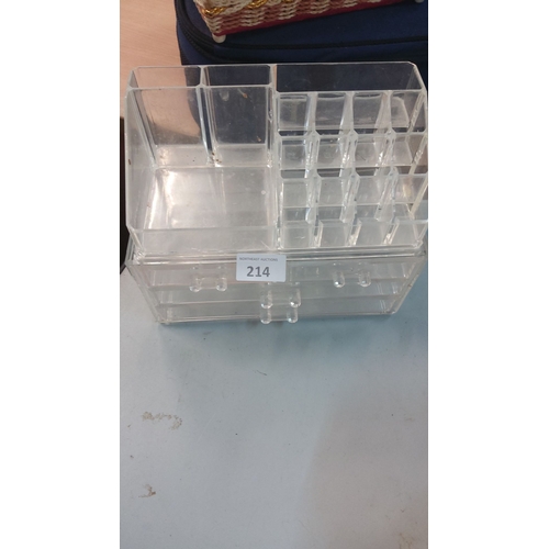214 - Acrylic makeup organizer with multiple compartments and drawers for storage.