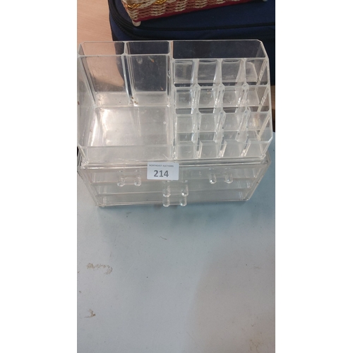 214 - Acrylic makeup organizer with multiple compartments and drawers for storage.