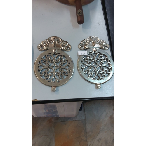217 - Pair of vintage chrome trivet stands with intricate scrollwork, reflecting a Victorian design influe... 