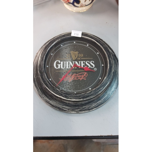 218 - Guinness wall clock features a weathered wood-effect frame and classic logo design.