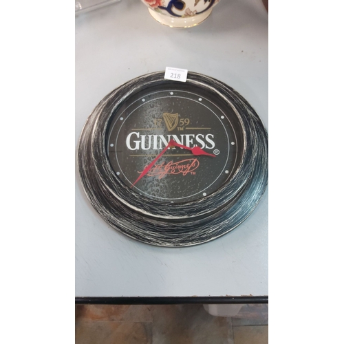 218 - Guinness wall clock features a weathered wood-effect frame and classic logo design.