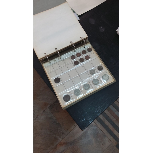 223 - Collection of assorted vintage coins in a binder with sleeves, including various denominations and d... 