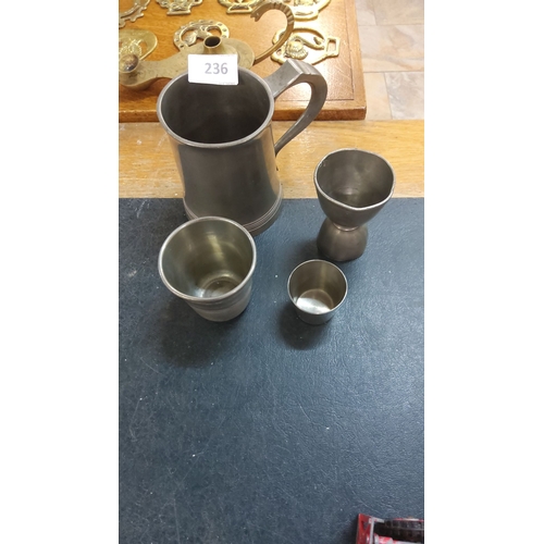 236 - Set of four pewter drinking measures, including a handled tankard and various cups. Simple yet elega... 